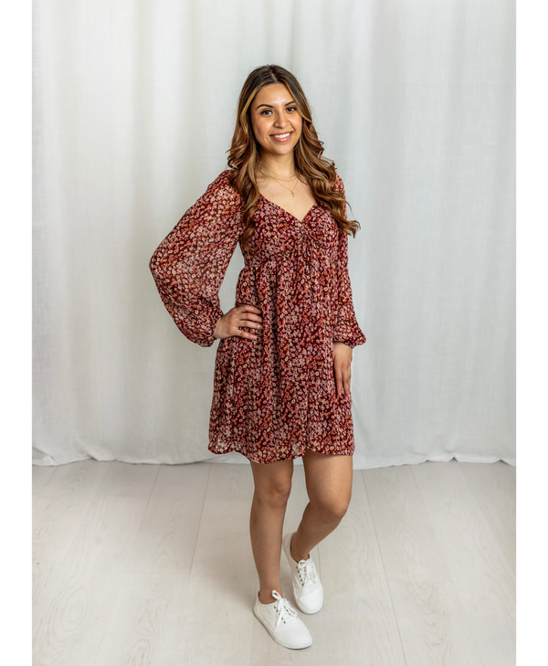 Women wearing a red floral dress with a sweatheart neckline
