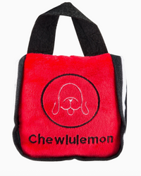 Red tote bag dog toy with black handle and 'Chewlulemon' branding on a white background