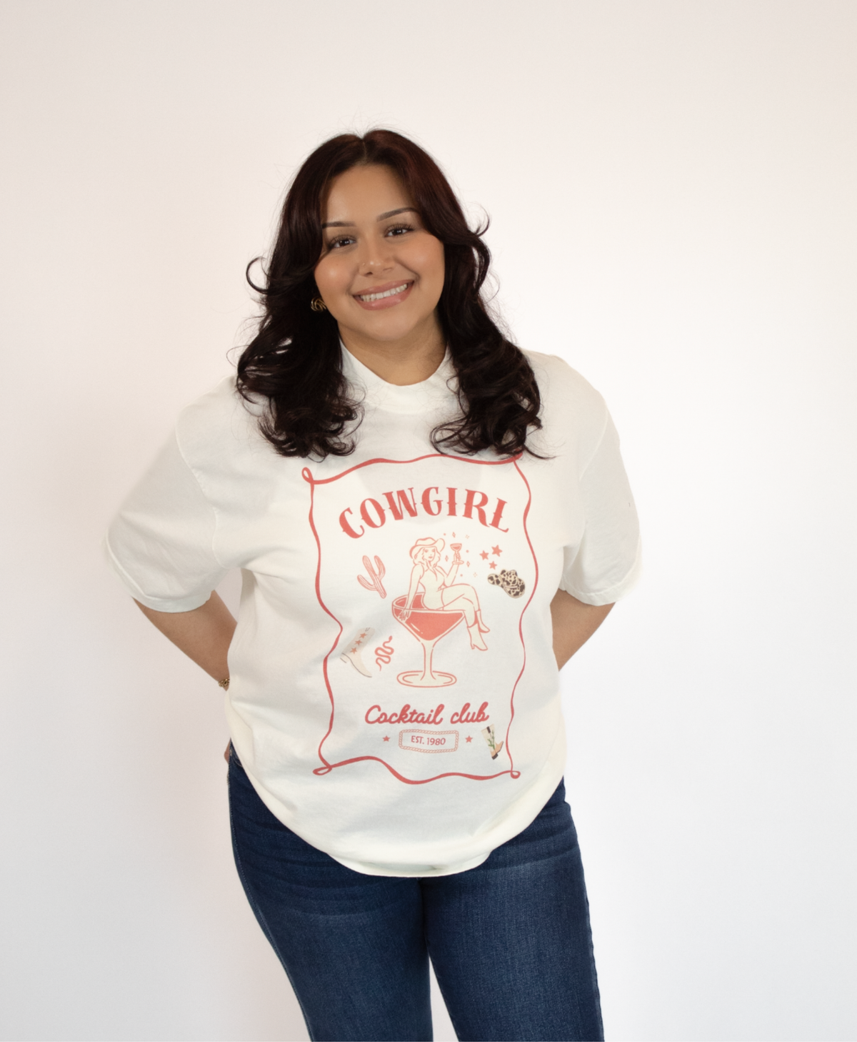 Women wearing a white t-shirt with a cowgirl in a cocktail design with jeans on a white background