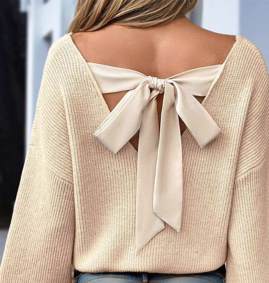 Back of beige sweater with a large bow