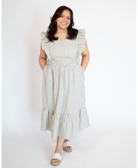 Woman wearing a striped full length cream colored dress with ruffle-trimmed short sleeves  against a white background