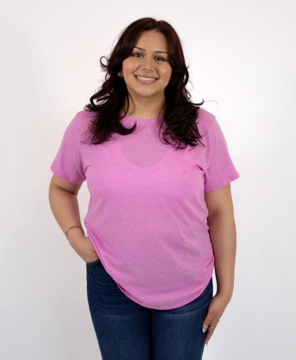 Woman wearing a pink t-shirt and blue jeans on a white background