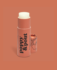 Lip balm stick with 'Poppy & Pout' branding on a peach background