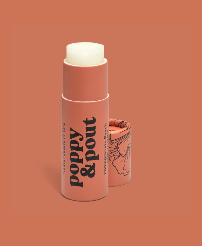 Lip balm stick with 'Poppy & Pout' branding on a peach background