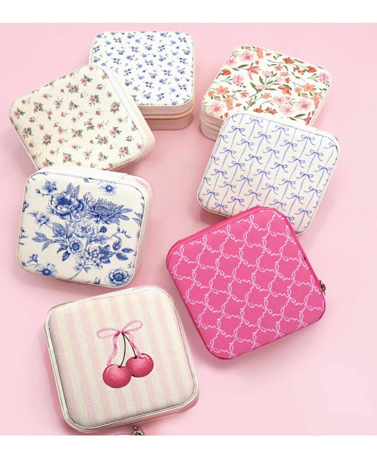 Travel jewelry boxes in a variety of designs on a pink background